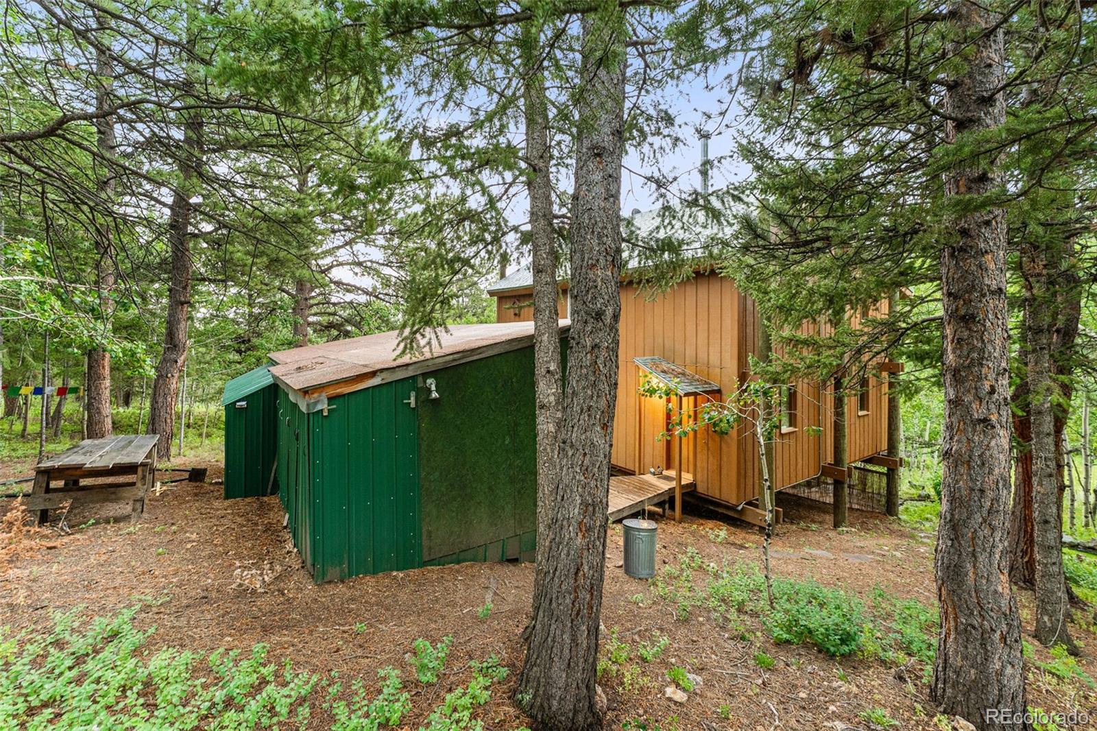 198 Range Road Nederland, CO 80466 - Photo 34 of 40 a view of a house with backyard and trees