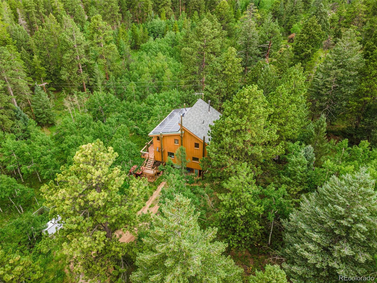 198 Range Road Nederland, CO 80466 - Photo 37 of 40 an aerial view of a house with a yard and outdoor seating