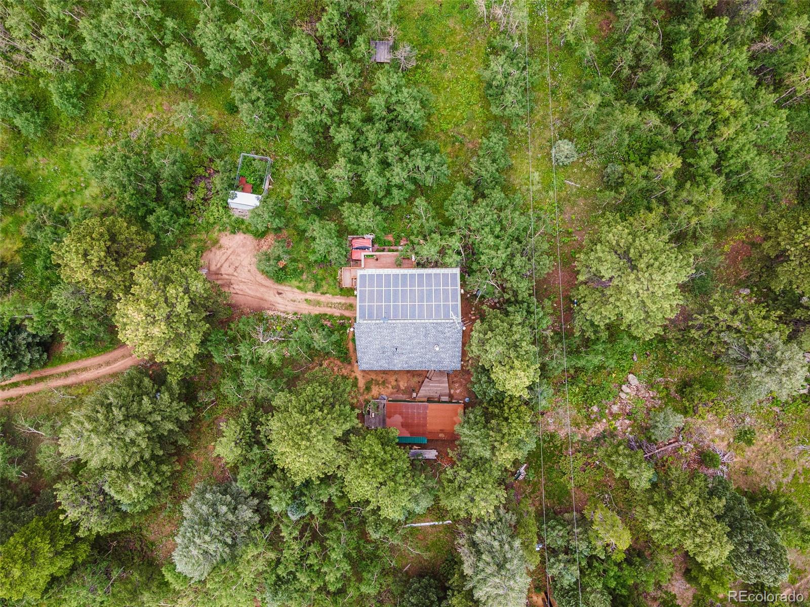 198 Range Road Nederland, CO 80466 - Photo 38 of 40 an aerial view of a house with a yard and trees all around