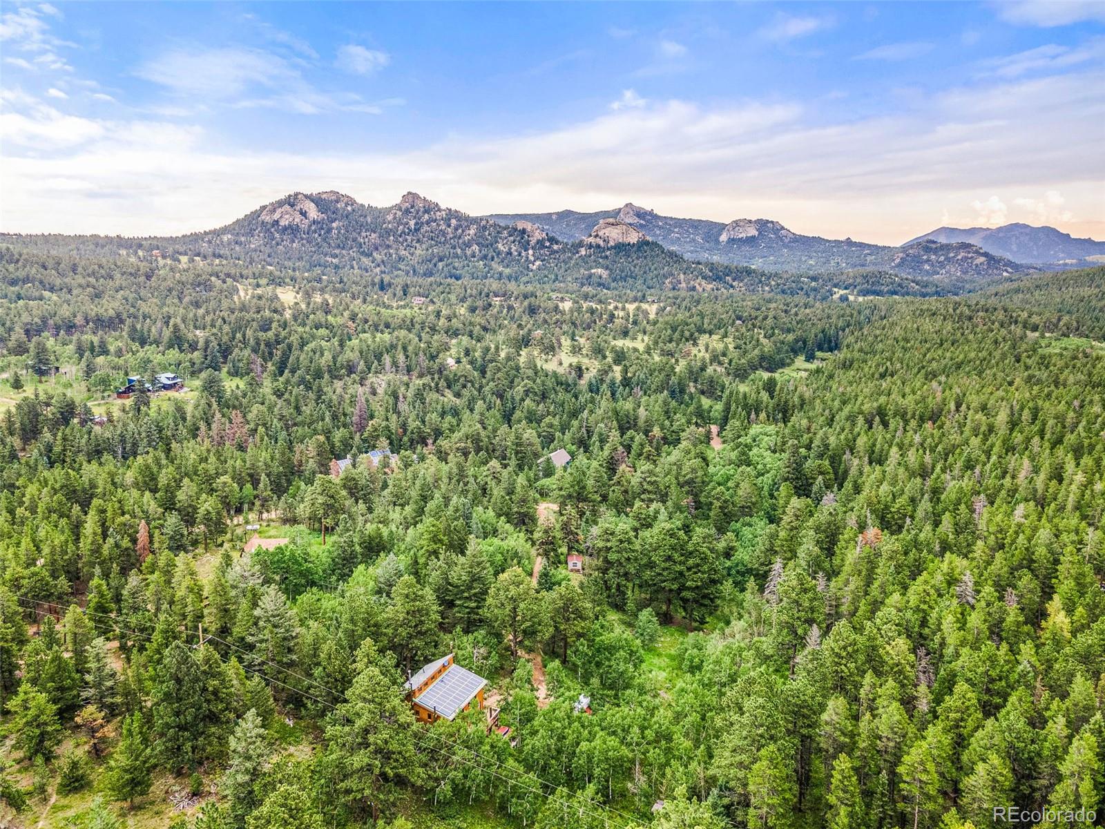 198 Range Road Nederland, CO 80466 - Photo 40 of 40 a view of a mountain range with lush green forest