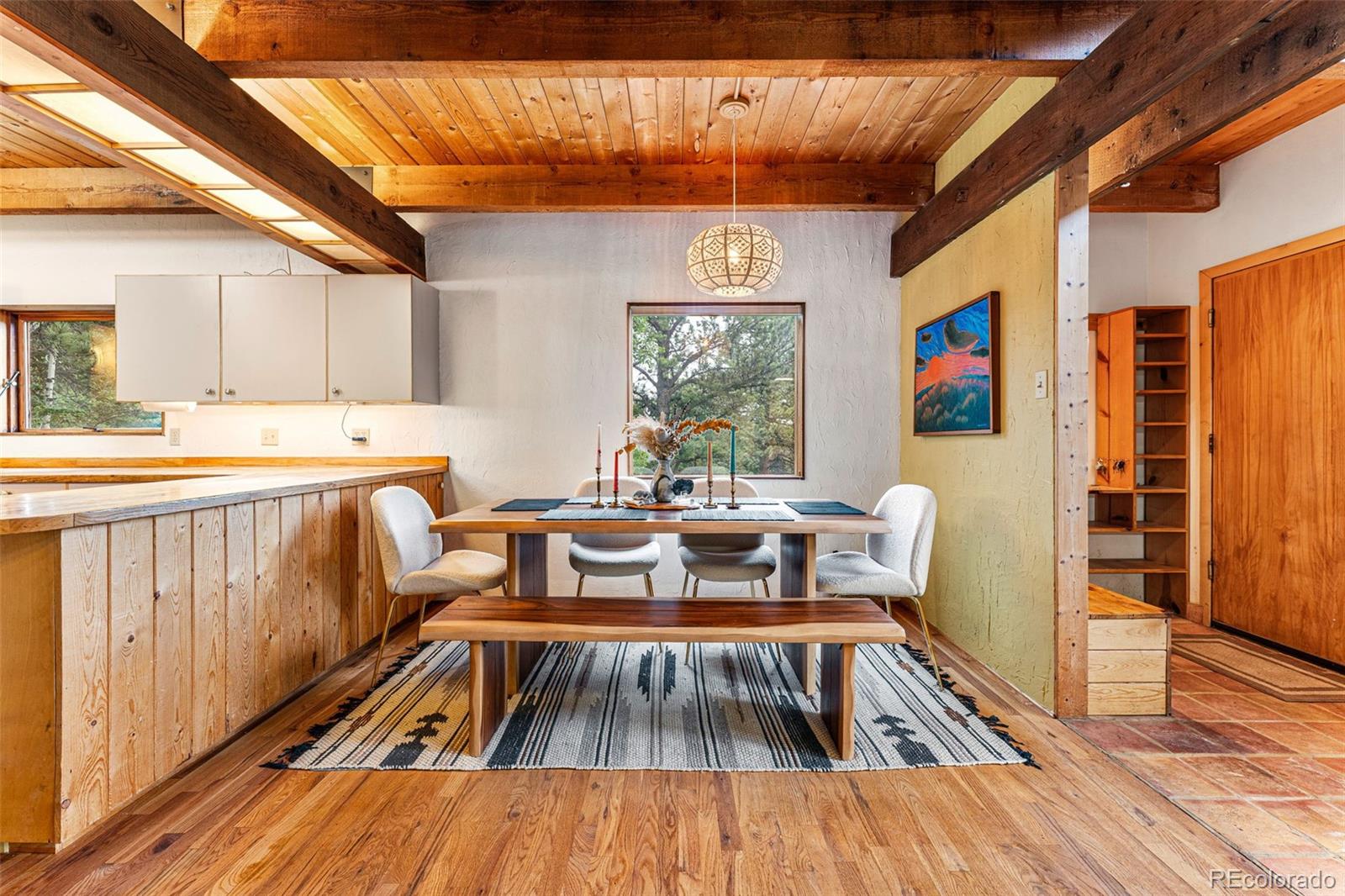198 Range Road Nederland, CO 80466 - Photo 9 of 40 a view of a dining room with furniture window and wooden floor