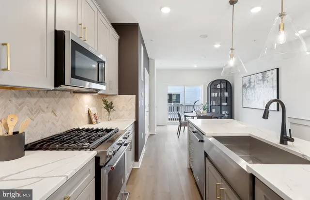 a kitchen with sink a stove and cabinets
