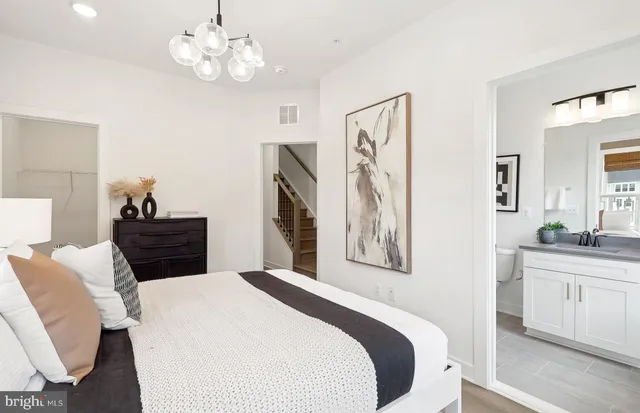 a bedroom with a bed and a chandelier