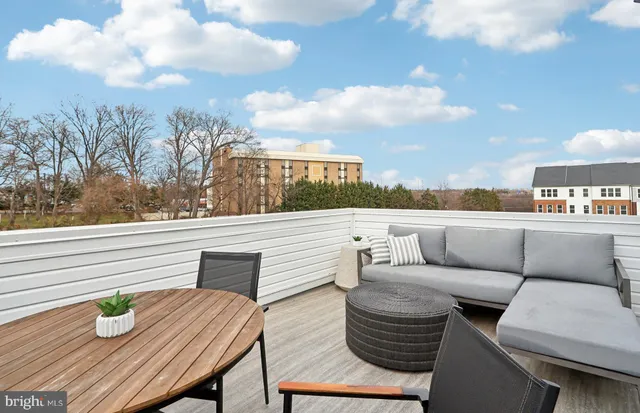 a balcony with table and chairs