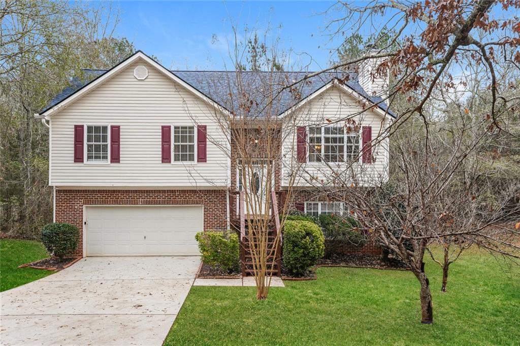 a front view of a house with a garden and plants