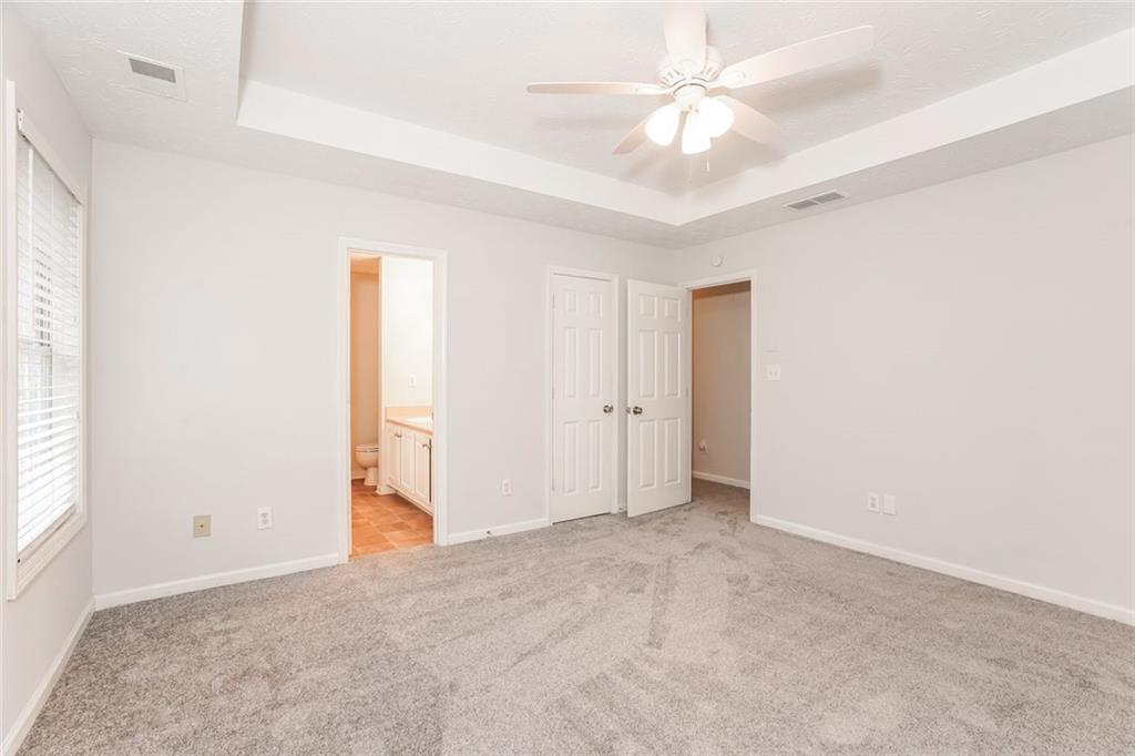 1024 Miss Amber Way Locust Grove, GA 30248 - Photo 13 of 25 an empty room with fan and a ceiling fan