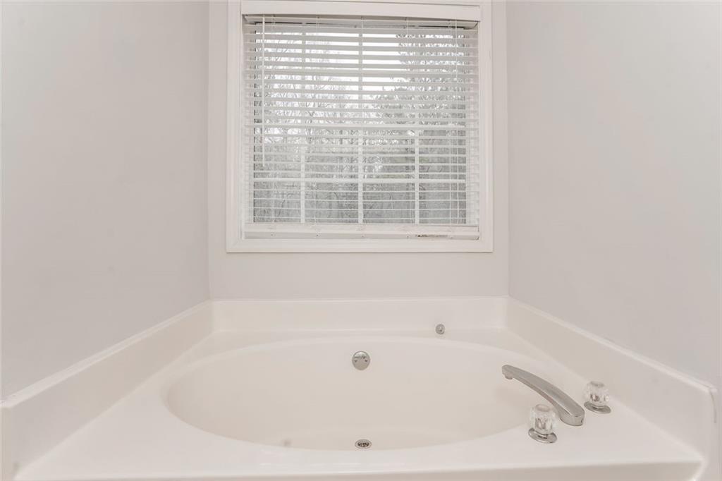 1024 Miss Amber Way Locust Grove, GA 30248 - Photo 16 of 25 a white bath tub sitting next to a window