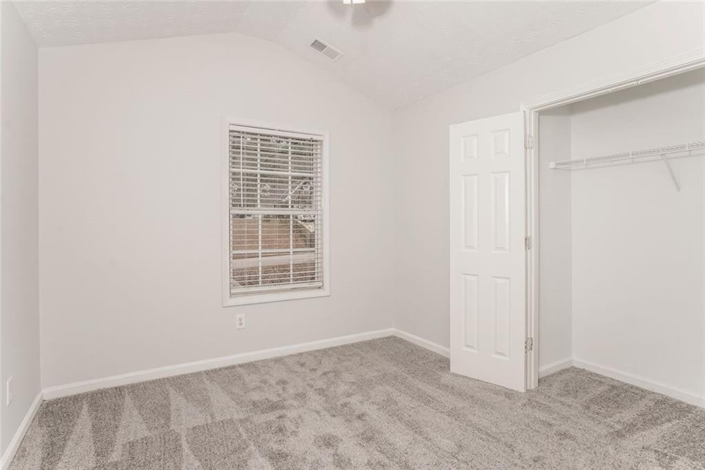 1024 Miss Amber Way Locust Grove, GA 30248 - Photo 17 of 25 an empty room with windows