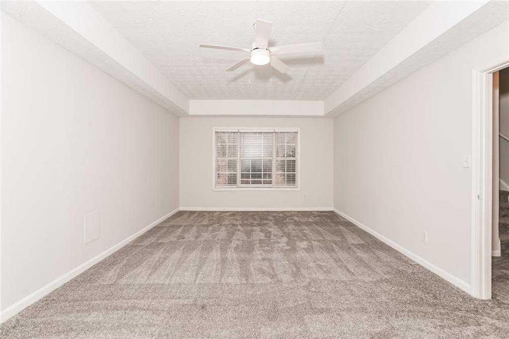 1024 Miss Amber Way Locust Grove, GA 30248 - Photo 18 of 25 an empty room with windows and ceiling fan