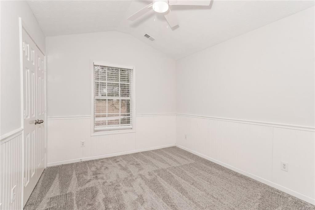 1024 Miss Amber Way Locust Grove, GA 30248 - Photo 19 of 25 an empty room with a empty space and windows
