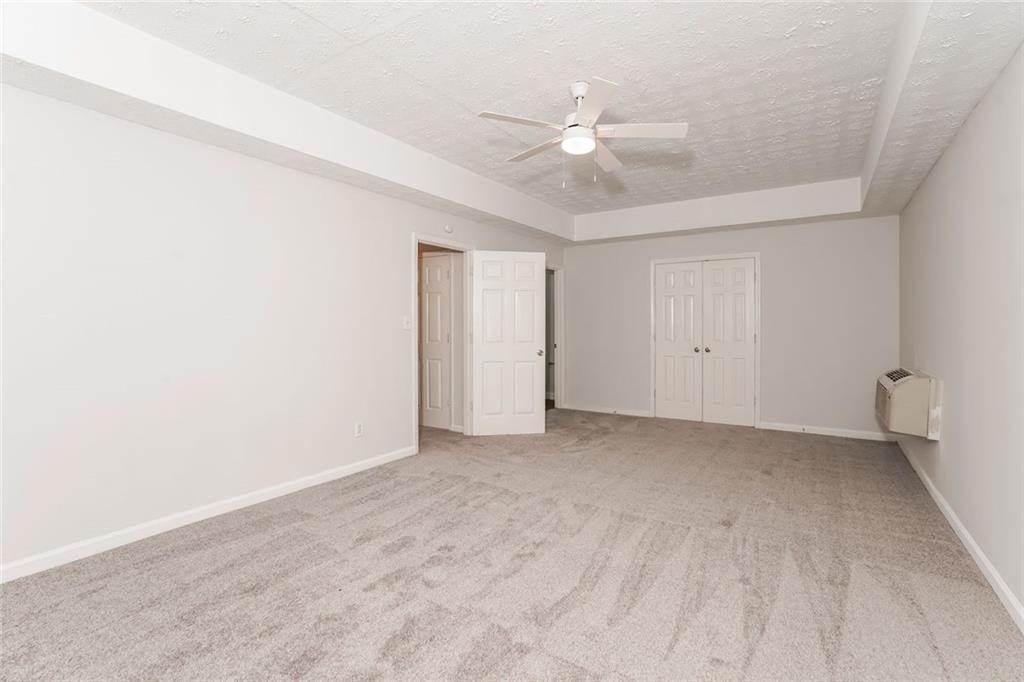 1024 Miss Amber Way Locust Grove, GA 30248 - Photo 21 of 25 a view of an empty room with a ceiling fan