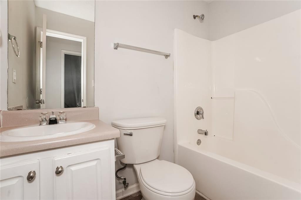 1024 Miss Amber Way Locust Grove, GA 30248 - Photo 22 of 25 a bathroom with a sink a toilet and shower