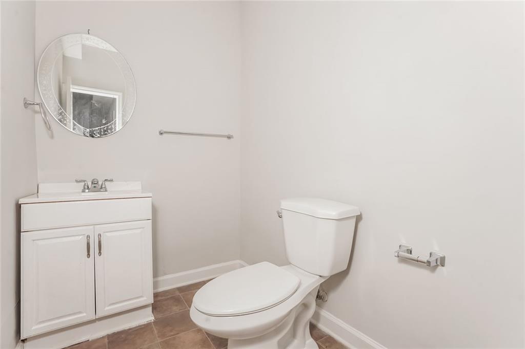 1024 Miss Amber Way Locust Grove, GA 30248 - Photo 23 of 25 a bathroom with a toilet sink and mirror