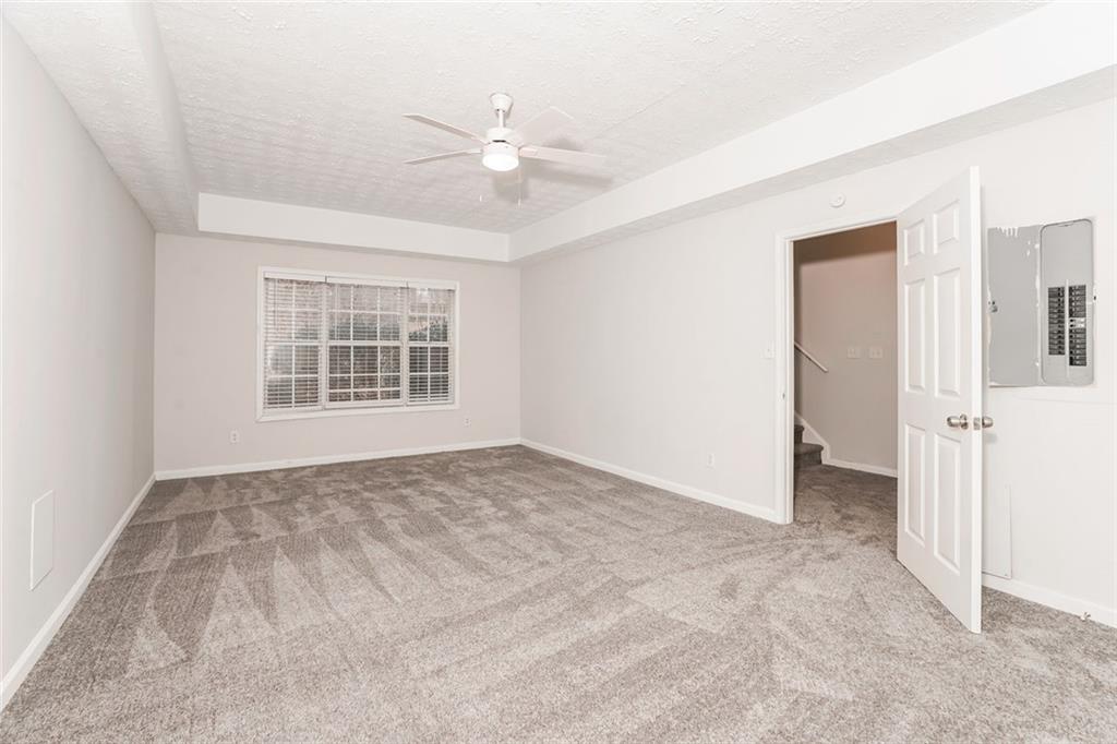 1024 Miss Amber Way Locust Grove, GA 30248 - Photo 25 of 25 an empty room with windows and fan