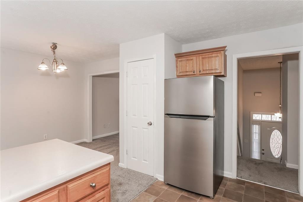 1024 Miss Amber Way Locust Grove, GA 30248 - Photo 7 of 25 a kitchen with a refrigerator and cabinets