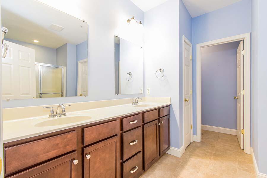 22 Southport Drive Mashpee, MA 02649 - Photo 15 of 27 a bathroom with a double vanity sink and a mirror