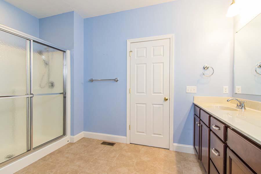 22 Southport Drive Mashpee, MA 02649 - Photo 16 of 27 a bathroom with a granite countertop sink and a mirror
