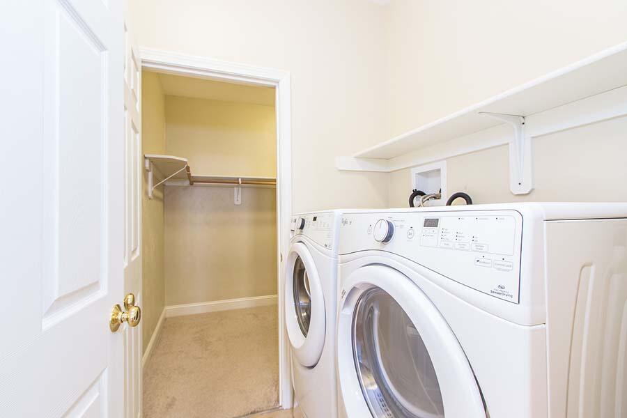 22 Southport Drive Mashpee, MA 02649 - Photo 20 of 27 a view of washer and dryer with kitchen in the background