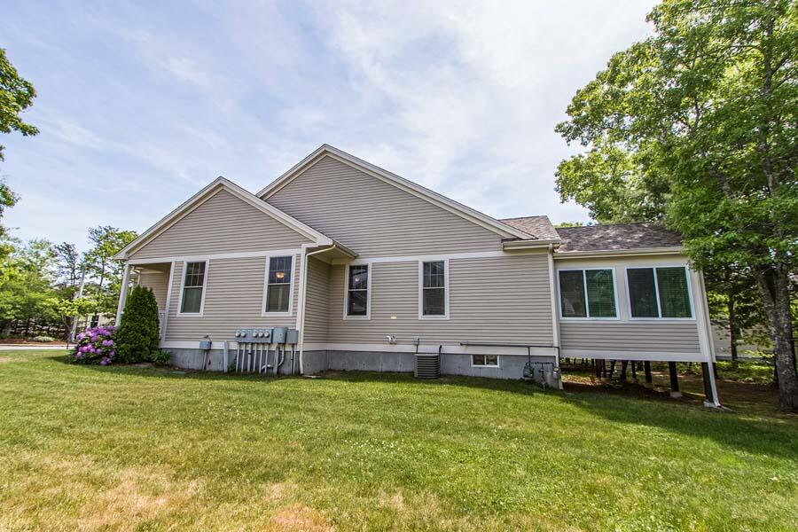 22 Southport Drive Mashpee, MA 02649 - Photo 24 of 27 a front view of house with yard and green space