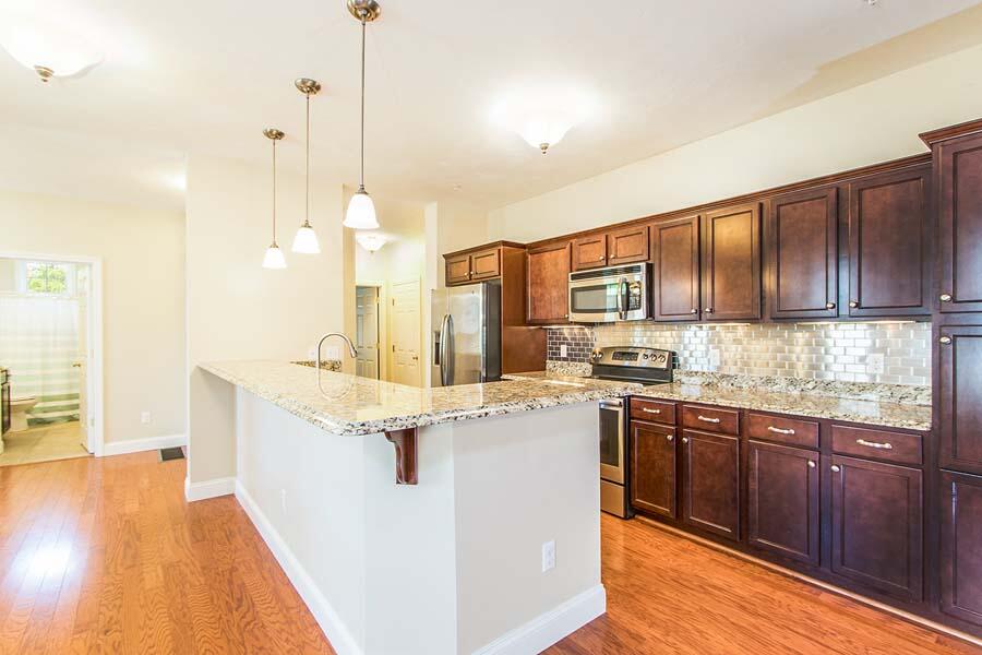 22 Southport Drive Mashpee, MA 02649 - Photo 6 of 27 a kitchen with stainless steel appliances granite countertop wooden cabinets sink and stove