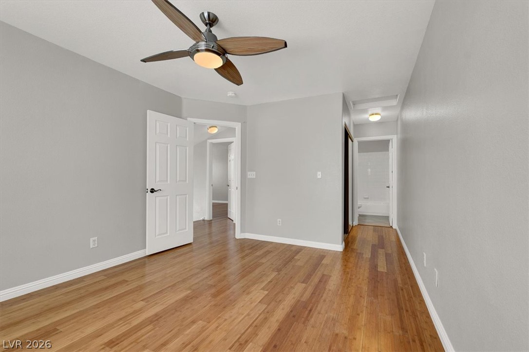 10148 Tree Bark Street Las Vegas, NV 89183 - Photo 22 of 37 Hardwood floors and a ceiling fan create a comfortable atmosphere in this ample space.