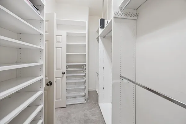 a view of walk in closet with empty racks