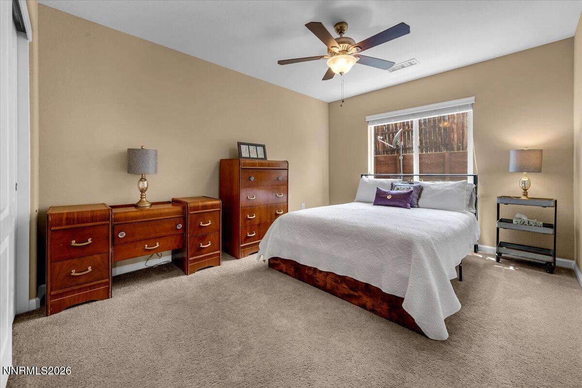 104 Bethpage Road Dayton, NV 89403 - Photo 32 of 65 a bedroom with a bed and a chandelier