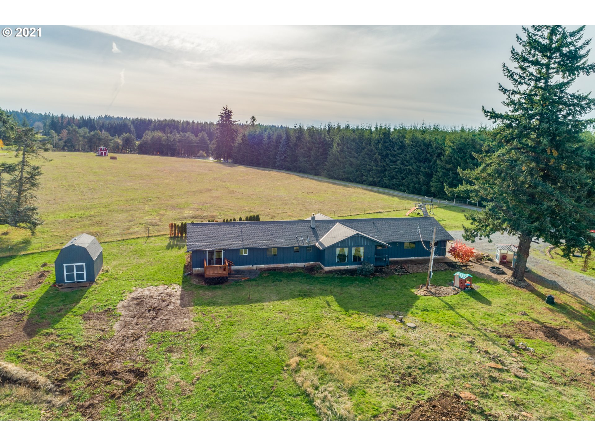 15587 South Pierce Road Molalla, OR 97038 - Photo 26 of 28 a view of a swimming pool with lawn chairs near a lake