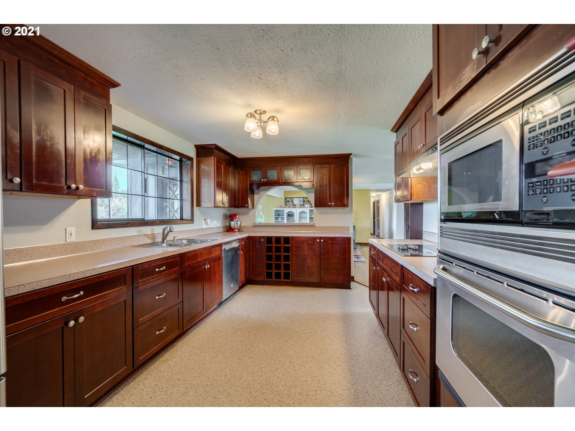 15587 South Pierce Road Molalla, OR 97038 - Photo 7 of 28 a large kitchen with stainless steel appliances wooden cabinets and a stove top oven