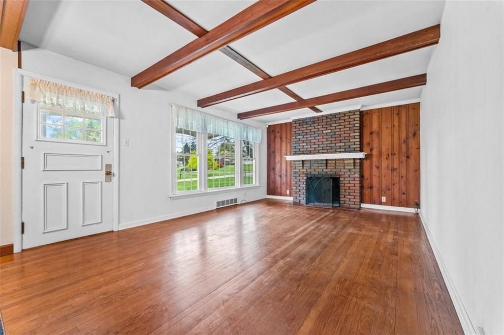 2417 Ridgewood Court New Castle, PA 16101 - Photo 2 of 3 a view of empty room with wooden floor and fireplace