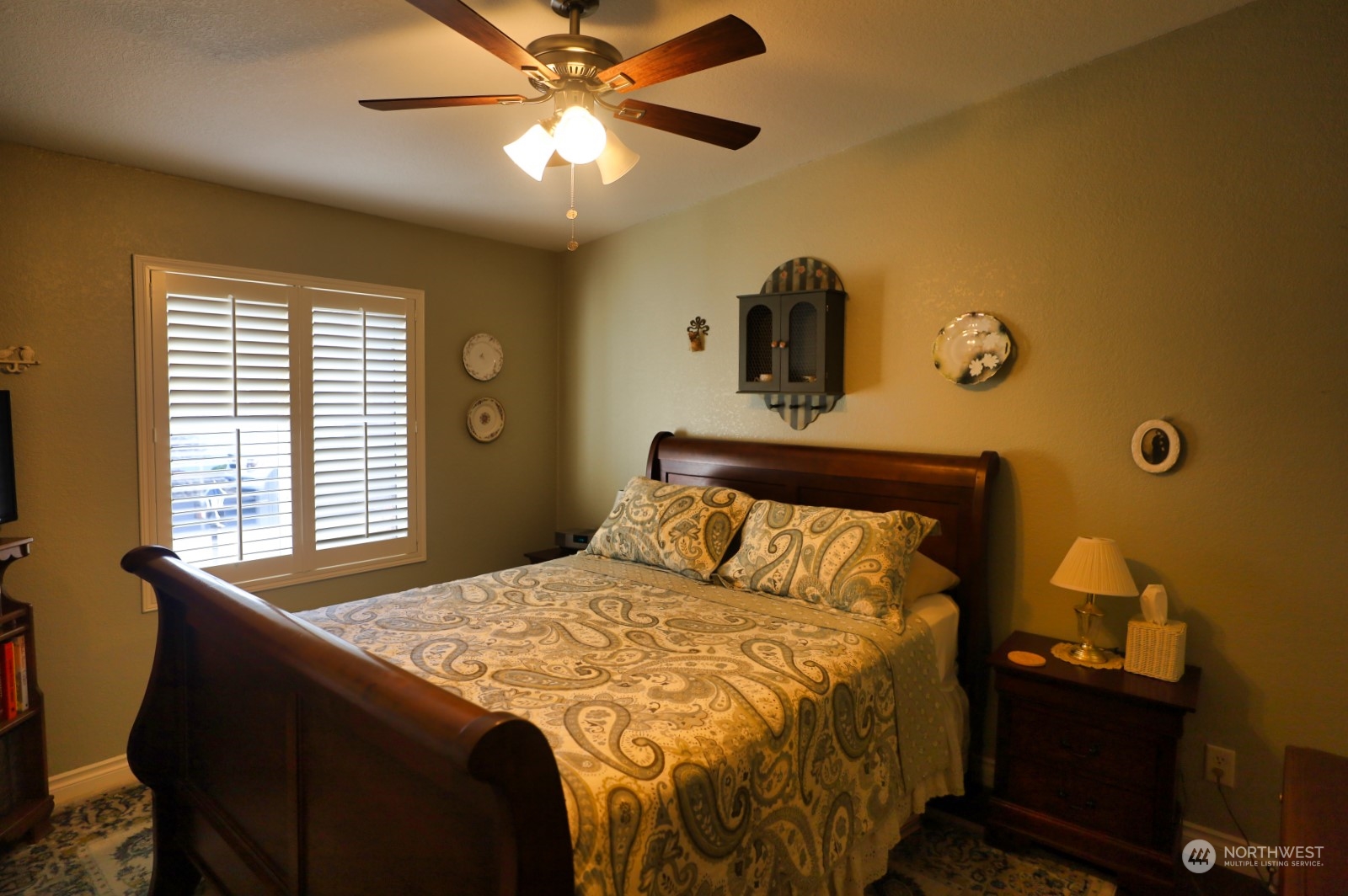 247 Ho Hum Lane Aberdeen, WA 98520 - Photo 17 of 24 a bedroom with a bed and a chandelier