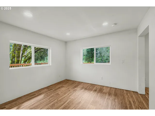 a view of a yard with large trees