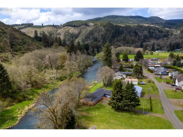 a view of a balcony with wooden floor and fence