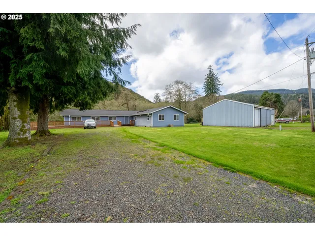 a view of a house with a garden and yard