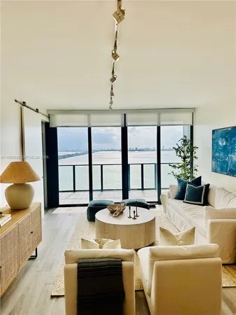 a living room with furniture and a large window