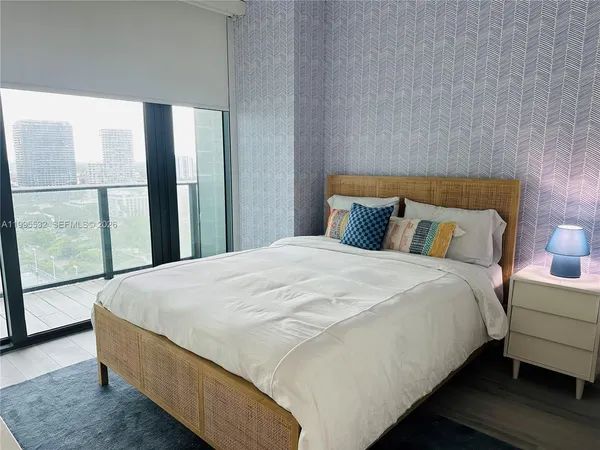 a bedroom with a bed and a lamp
