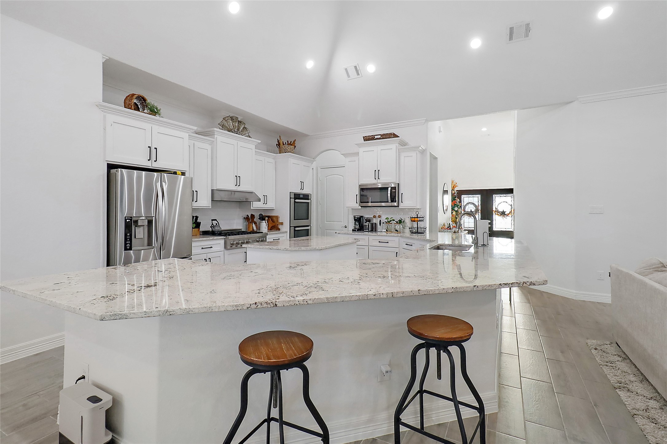 719 Cold Spring Drive Baytown, TX 77523 - Photo 14 of 33 a kitchen with stainless steel appliances granite countertop a sink and a refrigerator