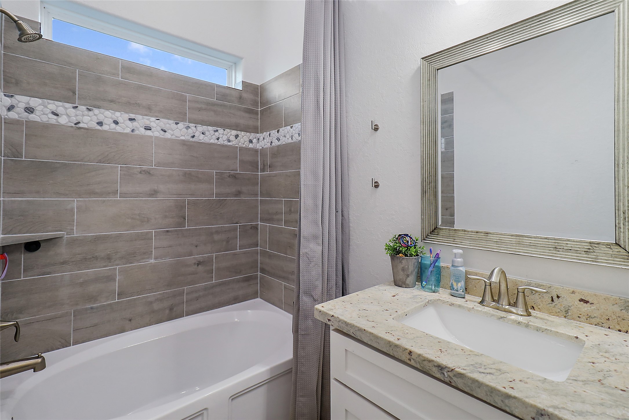 719 Cold Spring Drive Baytown, TX 77523 - Photo 25 of 33 a bathroom with a granite countertop bathtub shower sink and vanity