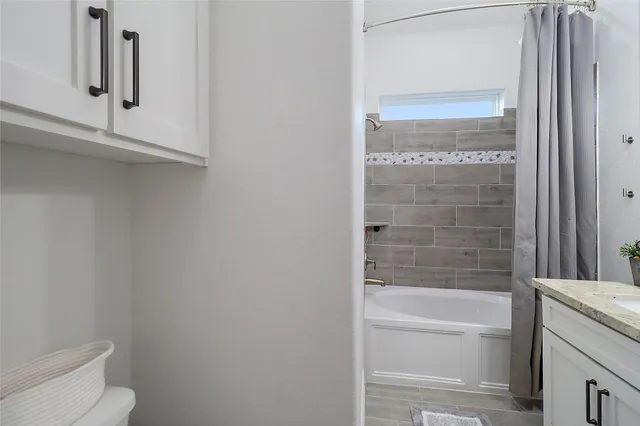 a bathroom with a bathtub and a toilet