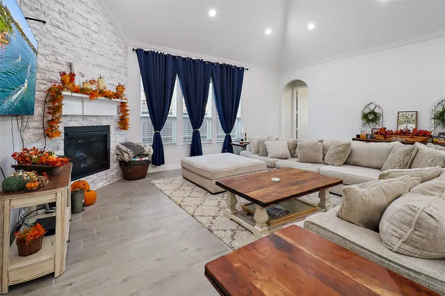 a living room with furniture a fireplace and a table