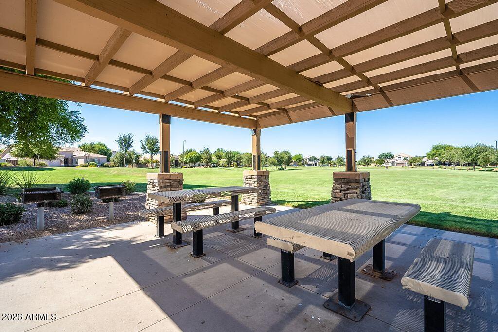 4168 East Sandy Way Gilbert, AZ 85297 - Photo 39 of 47 a view of a patio with table and chairs couches with wooden floor and a yard