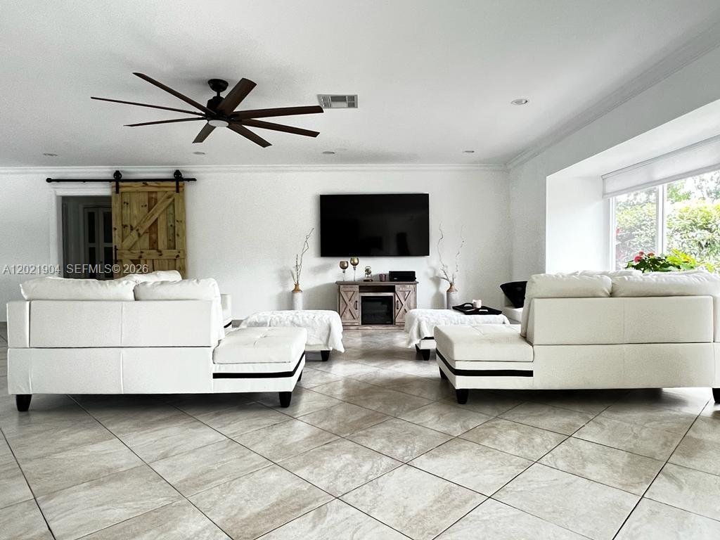 3324 Lakeview Boulevard Delray Beach, FL 33445 - Photo 6 of 36 a living room with furniture and a flat screen tv