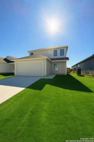 a view of house with backyard