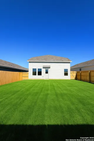 a view of a house with a back yard