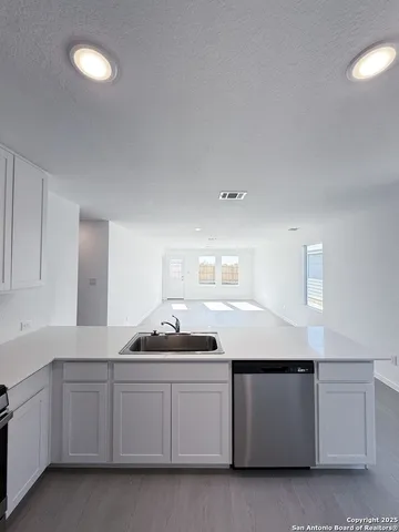 a kitchen with a sink and cabinets