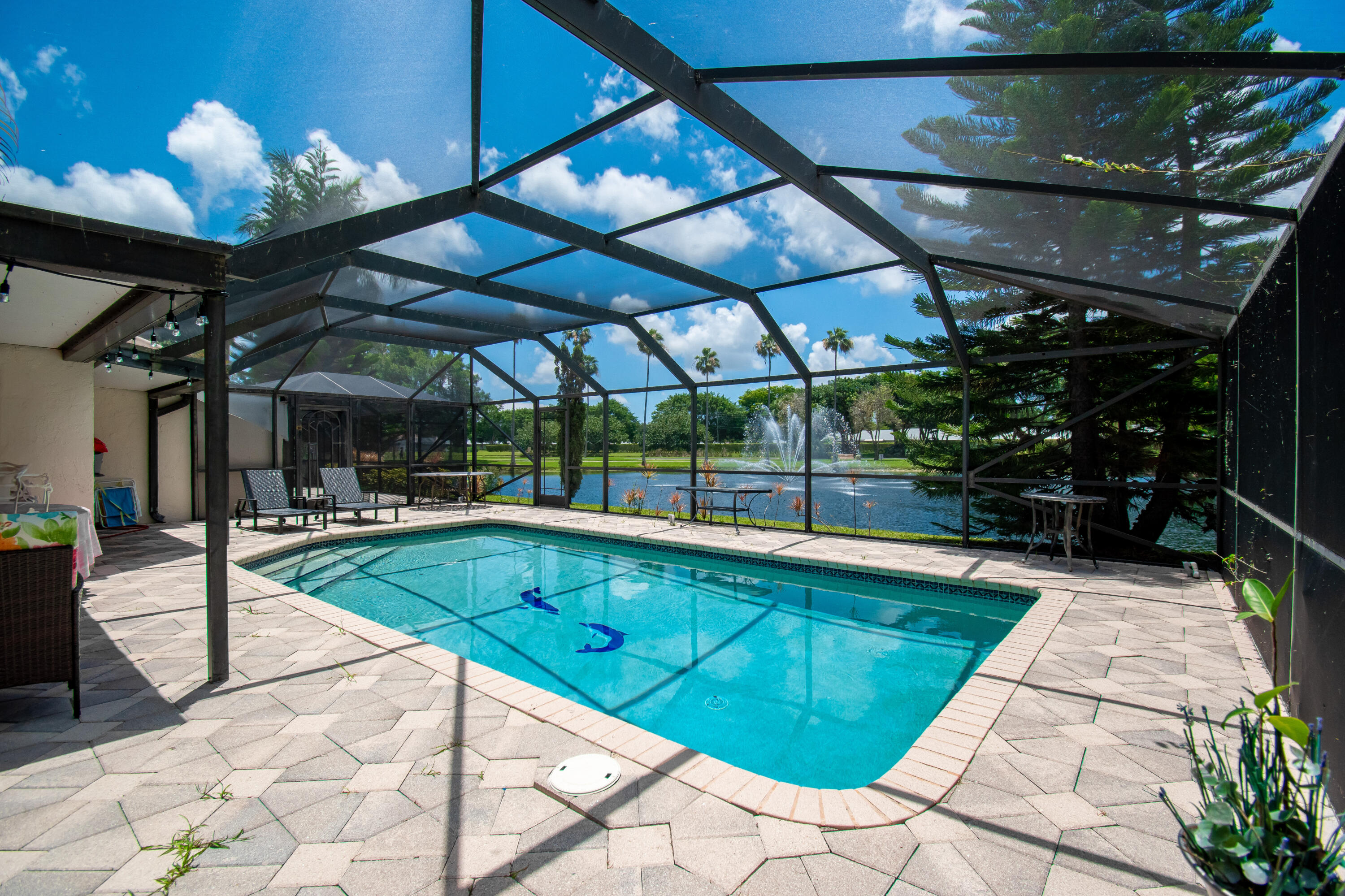 a view of a backyard with swimming pool