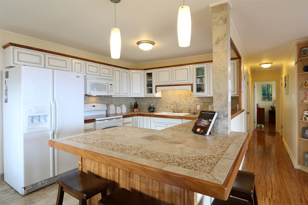 426 Ainakula Road Kula, HI 96790 - Photo 3 of 21 a kitchen with kitchen island a sink stove and refrigerator