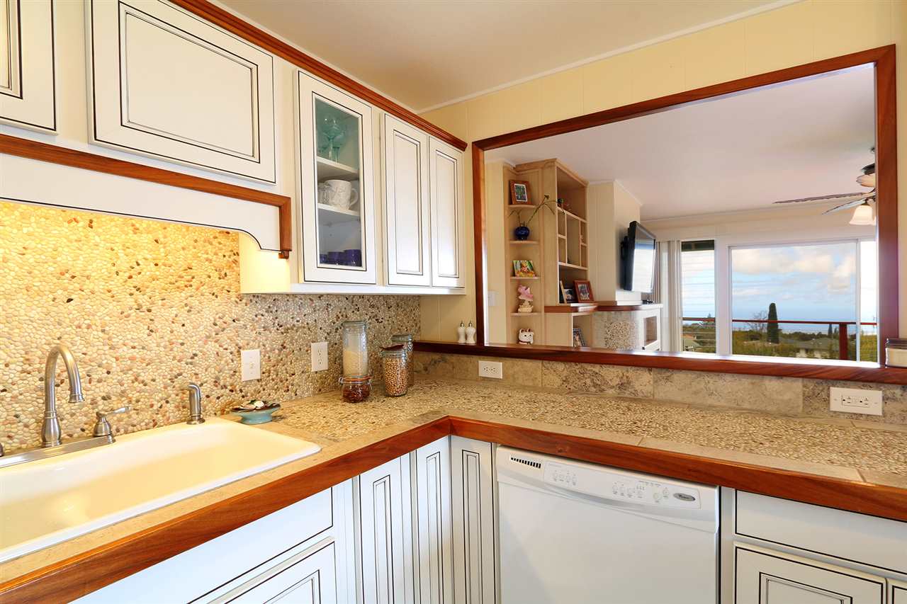 426 Ainakula Road Kula, HI 96790 - Photo 4 of 21 a bathroom with a granite countertop sink and large mirror