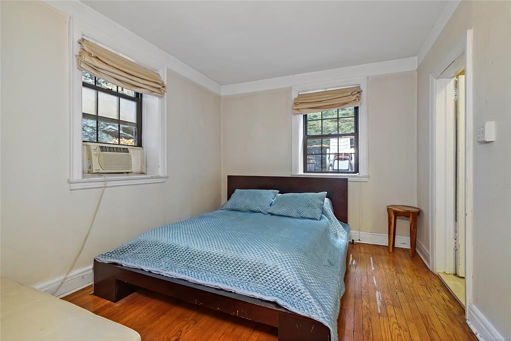 26 Pondfield Road, Unit E Bronxville, NY 10708 - Photo 7 of 10 Bedroom featuring multiple windows, cooling unit, and wood-type flooring