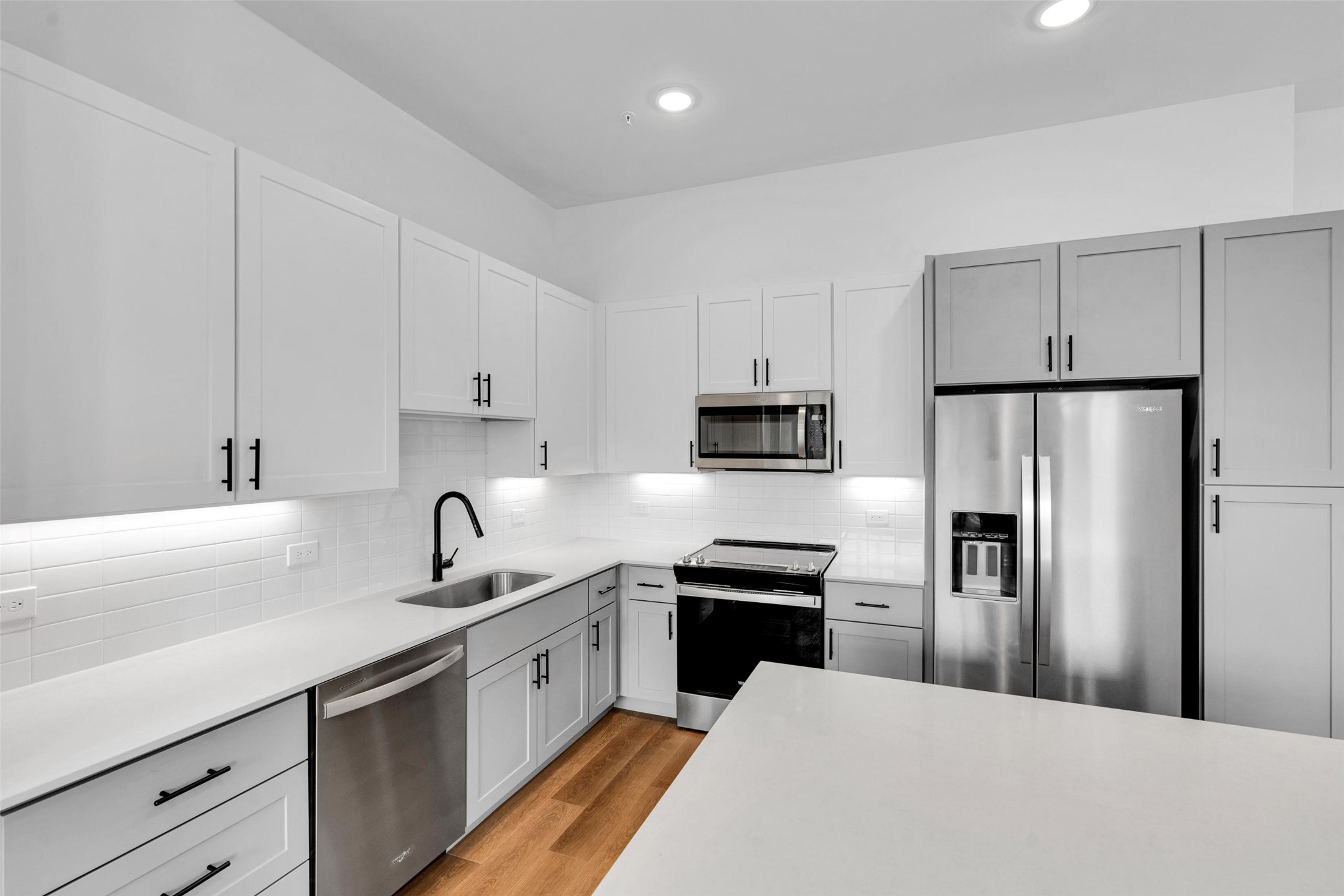 1424 A Forward Drive Little Elm, TX 75068 - Photo 5 of 28 a kitchen with white cabinets and stainless steel appliances